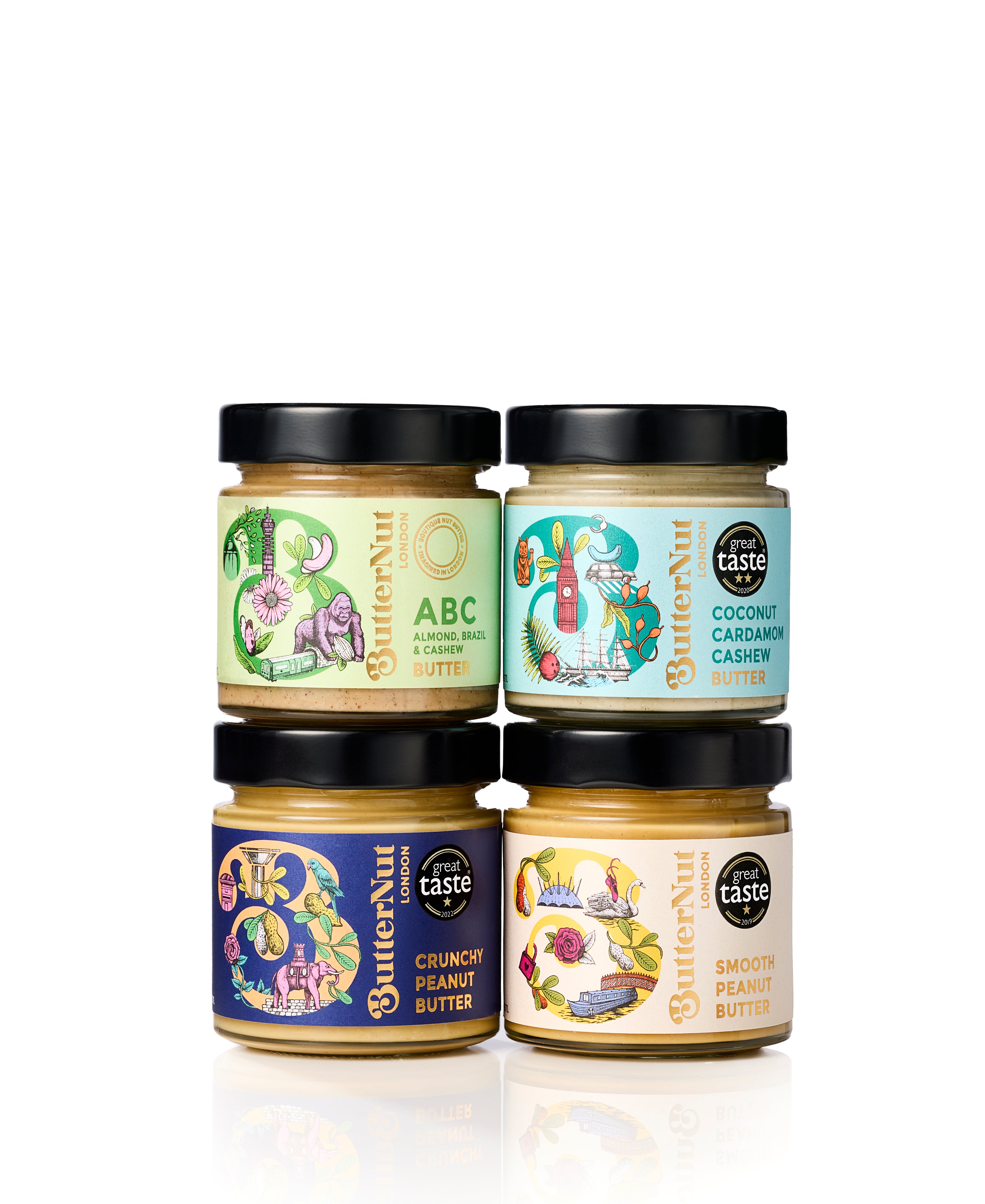Four jars of ButterNut gourmet spread arranged in a 2x2 grid on a white background. The jars feature colorful labels for various flavors: ABC Chocolate Butter, Coconut Cashew Butter, Crunchy Peanut Butter, and Smooth Peanut Butter, all with black lids.