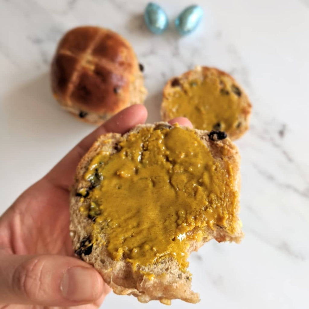 Image of hot cross buns topped with Cashew Maple Turmeric nut butter.
