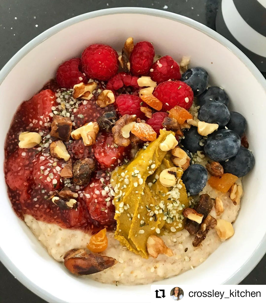 Image of porridge topped with raspberries, blueberries chopped nuts and and Butter Nut of London's Cashew Maple Turmeric | Photo by @crossley_kitchen